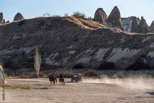People doing safari with beautiful horses and ATV in Cappadocia with the scenery of fairy chimneys © attraction art