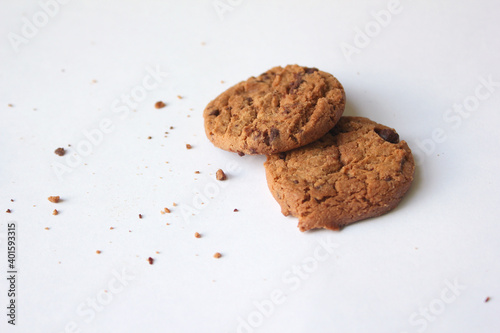 Chocolate chip cookies with crumbs isolated on white background