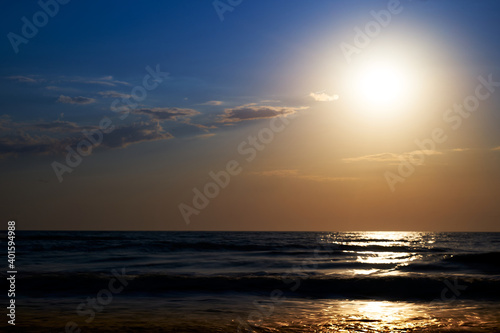 Sea sunset. Quiet calm sea. Sand beach.
