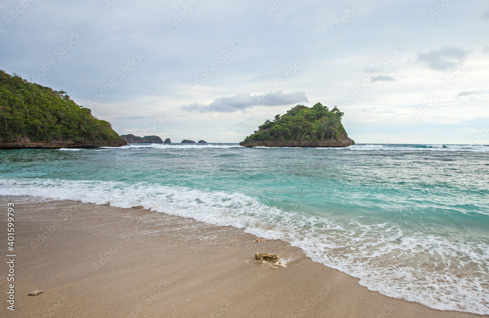 Beautiful view of a small island in Teluk Asmara (love bay) Beach. The beach is located in South Malang, Malang Regency, East Java