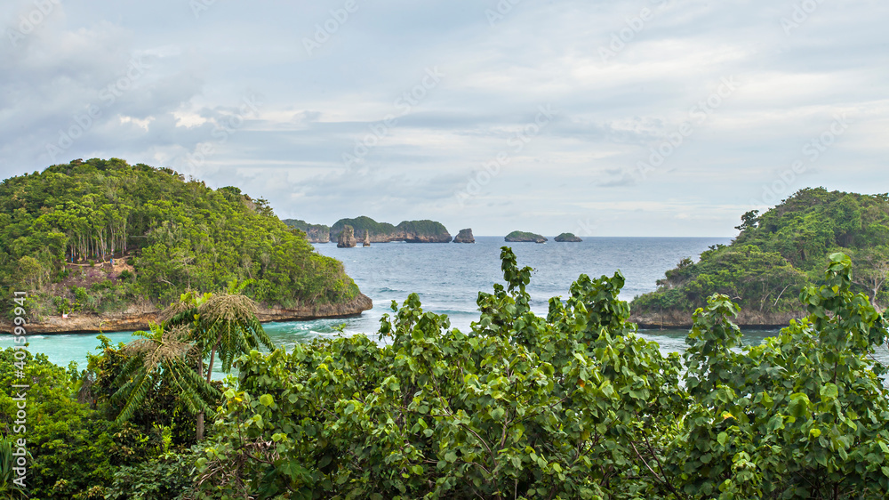 Beautiful view of a small island in Teluk Asmara (love bay) Beach. The beach is located in South Malang, Malang Regency, East Java