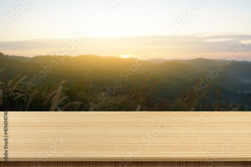 wooden table top with the mountain landscape can be used to display or edit your products, simulate to showcase them. © Sutthiphong