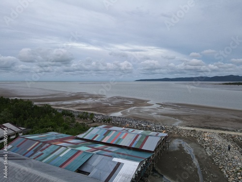 Buntal, Sarawak Malaysia - December 25, 2020: The Beautiful Fishing Village of Buntal at Sarawak Malaysia, beside the South China Sea, with the mighty Mount Santubong as the background photo