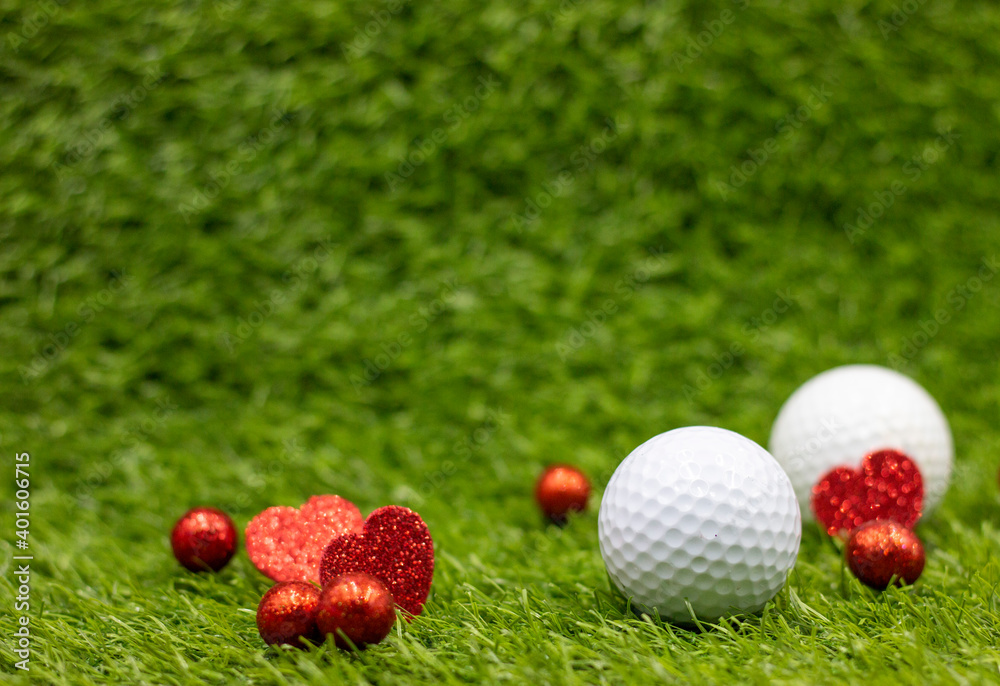 Naklejka premium Golf ball for Valentine's Day with red heart are on green grass with love