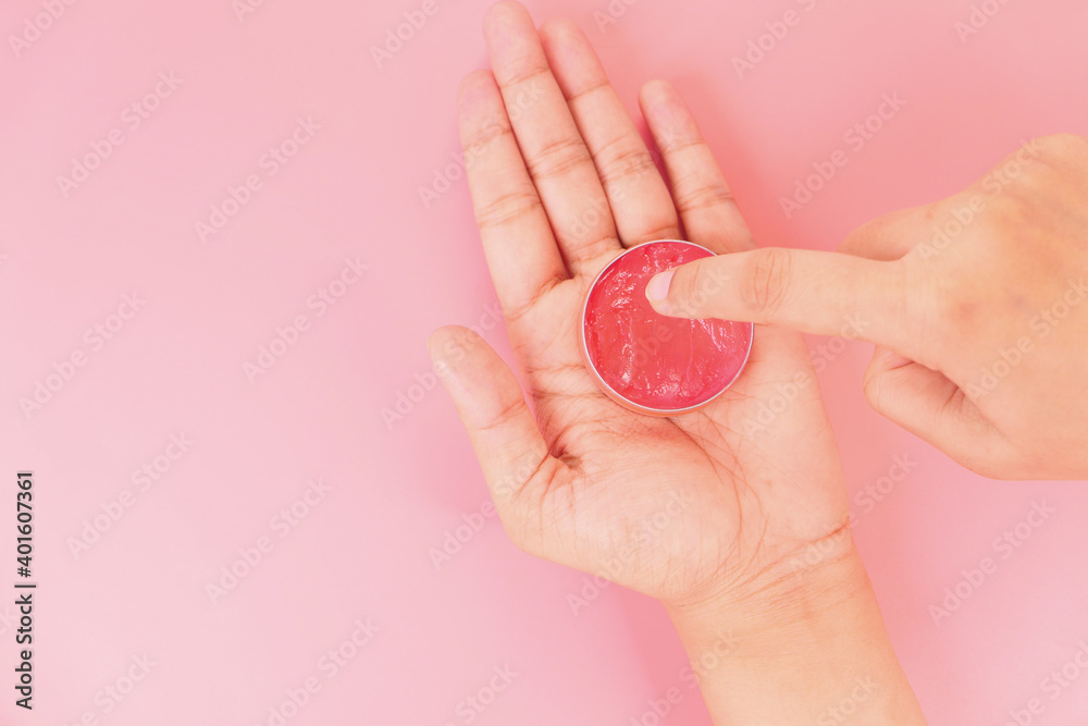 woman using petroleum jelly onto skin at home close up. woman using petroleum jelly onto skin at home close up.