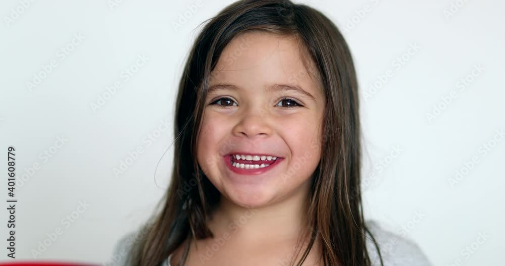 Happy little girl smiling at camera. Cute adorable child portrait face Happy little girl smiling at camera. Cute adorable child portrait face
