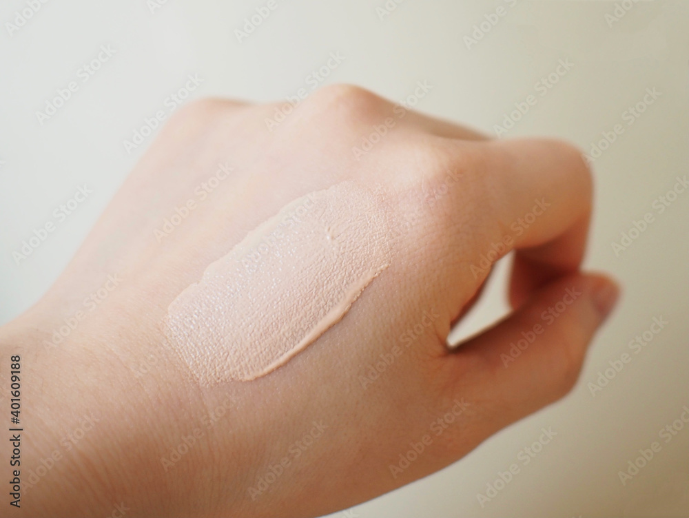 foundation testing on back of woman's hand foundation testing on back of woman's hand