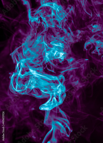 Purple and blue smoke isolated on black background. Abstraction