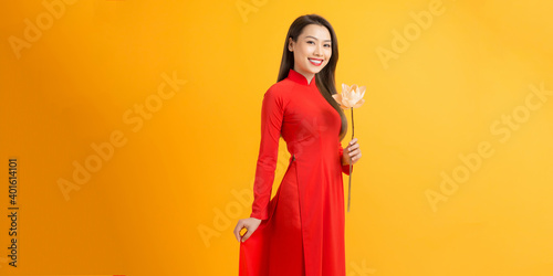 Vietnamese girl holding a lotus flower, The Ao dai ( long-dress Vietnamese) is traditional costume of Vietnamese woman