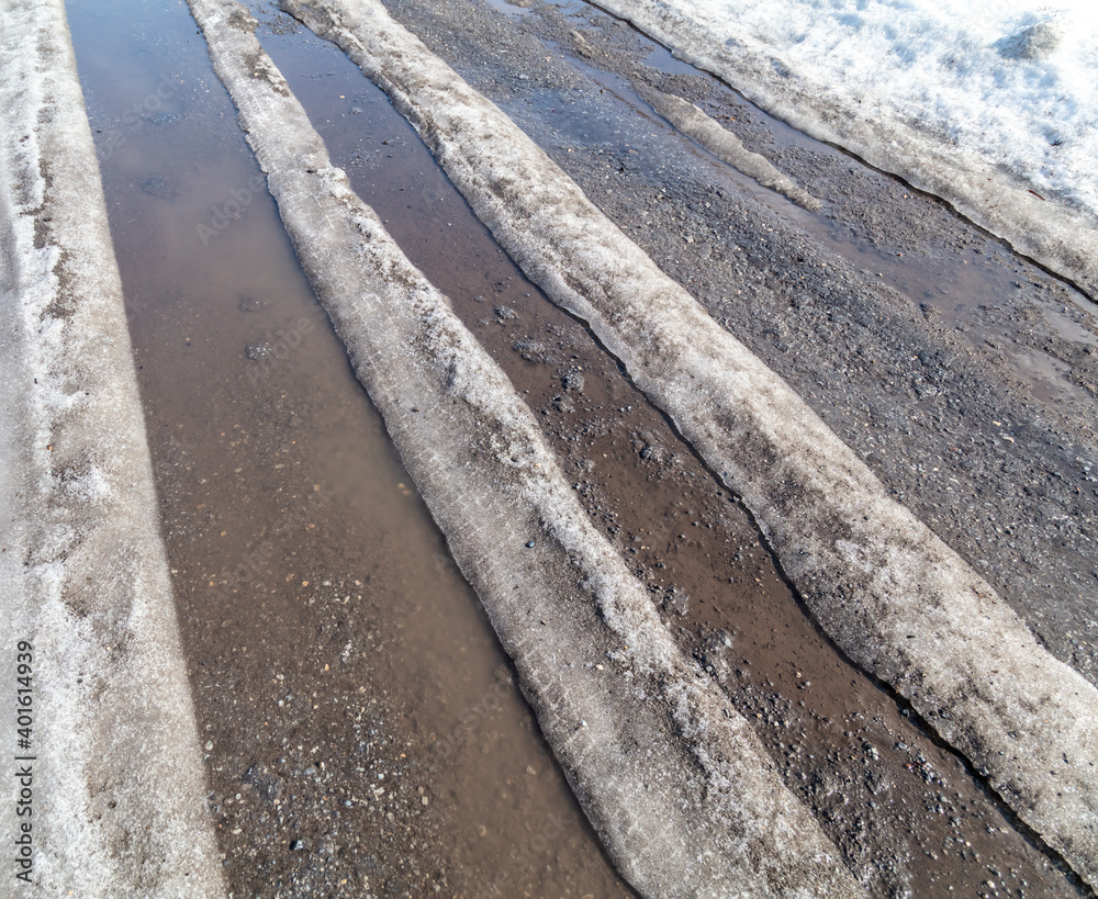 The road with melting snow in nature. The road with melting snow in nature.