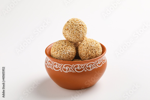 Indian sweet for traditional festival makar sankranti :Rajgira laddu made from Amaranth seed in Bowl on white background photo