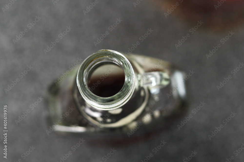 Open bottle with maple syrup. Directly above. Open bottle with maple syrup. Directly above.