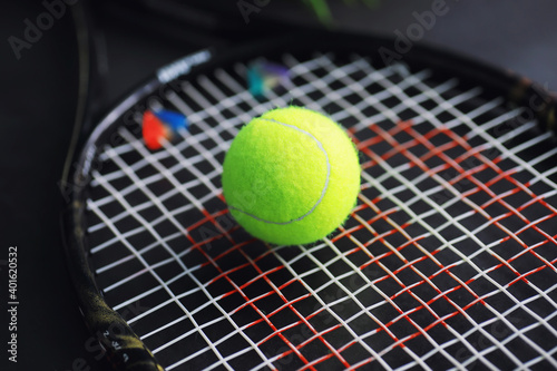 Sport and healthy lifestyle. Tennis. Yellow ball for tennis and a racket on the table. Sports background with tennis concept. © alexkich