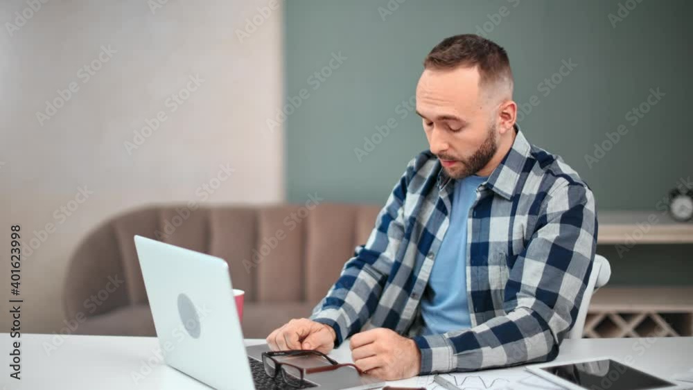 Upset freelancer man having work problem stress sitting on desk. Shot with RED camera in 4K Upset freelancer man having work problem stress sitting on desk. Shot with RED camera in 4K
