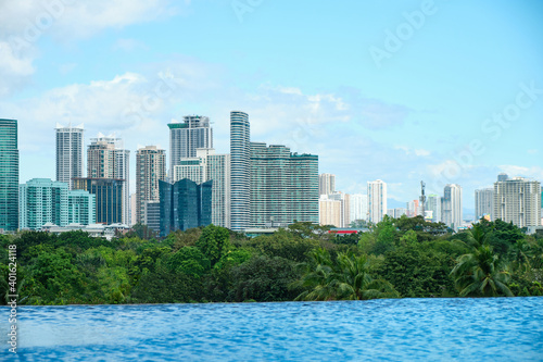 View of the city of Manila from the pool of the luxury five-star Discovery Primea hotel. Sunny weather. Skyscrapers on the background. © rdv27