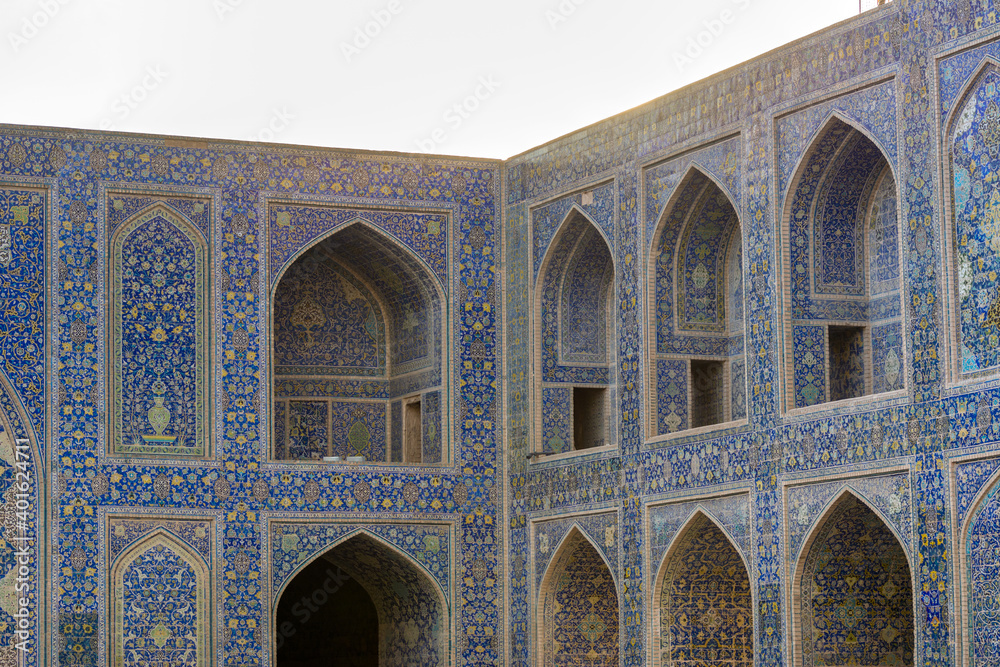 Arches of Historic buildings with persian blue tiles on the wall of Shah Mosque, situated on the south side of Naqsh-e Jahan Square  , an important historical site.