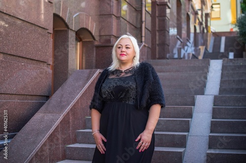  Beautiful woman on a walk in the city. Spring - summer time. A nice middle aged plus size woman at the street. Citizen lifestyle