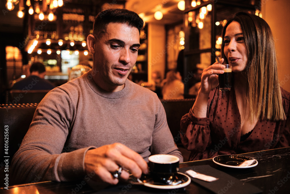 Couple drinking a cup of coffee at restaurant.