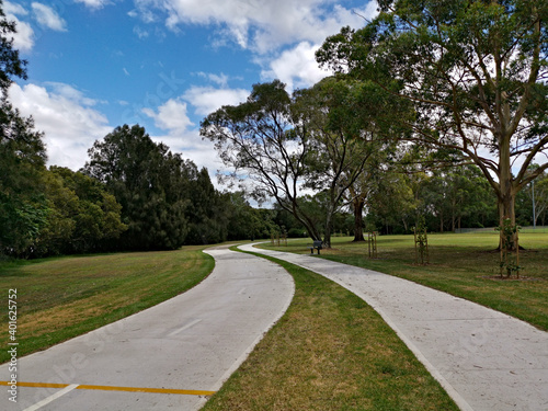 Fototapeta Naklejka Na Ścianę i Meble -  Beautiful view of a park with double trail, cycling and walking trail running along side by side, Rydalmere, Sydney, New South Wales, Australia
