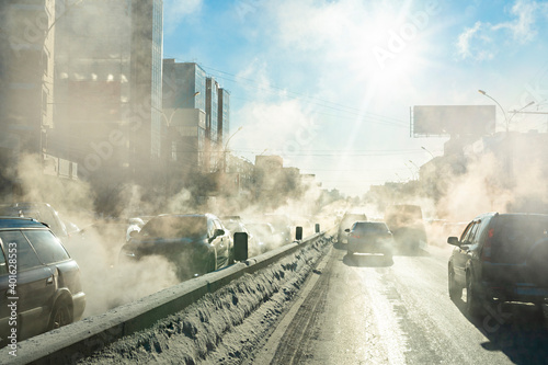 pollution from the exhaust of cars in the city in the winter. Smoke from cars on a cold winter day