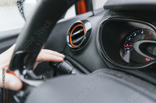 man's hand in the car putting the turn signal. driving concept