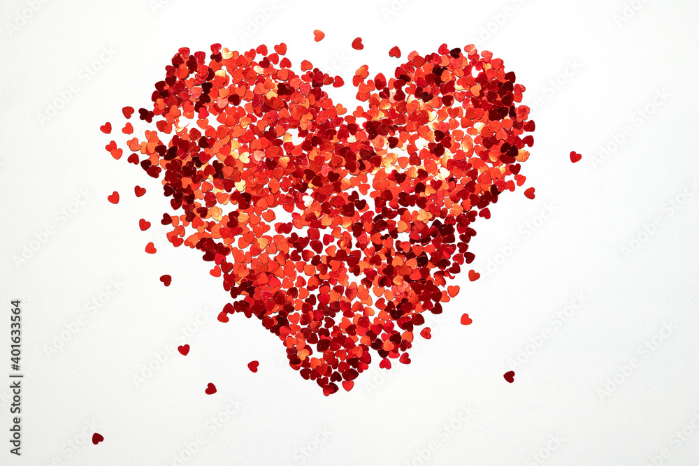 Flat lay heart made of lots of small red glitter hearts as symbol of love for valentine day Flat lay heart made of lots of small red glitter hearts as symbol of love for valentine day