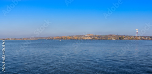 Panorama. Beautiful natural landscape on the Dnieper river with fishermen on the background of a green island and blue sky