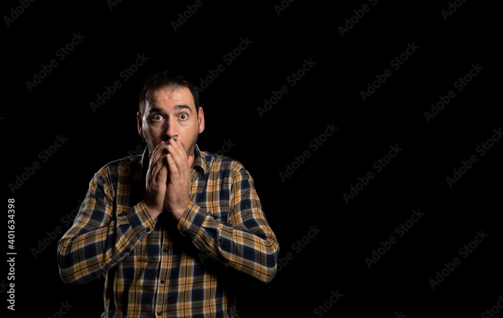 I'm scared. Scare. Portrait of the scared man. Isolated on a black studio background. Half-length portrait. Human emotions, facial expression concept. copy space I'm scared. Scare. Portrait of the scared man. Isolated on a black studio background. Half-length portrait. Human emotions, facial expression concept. copy space