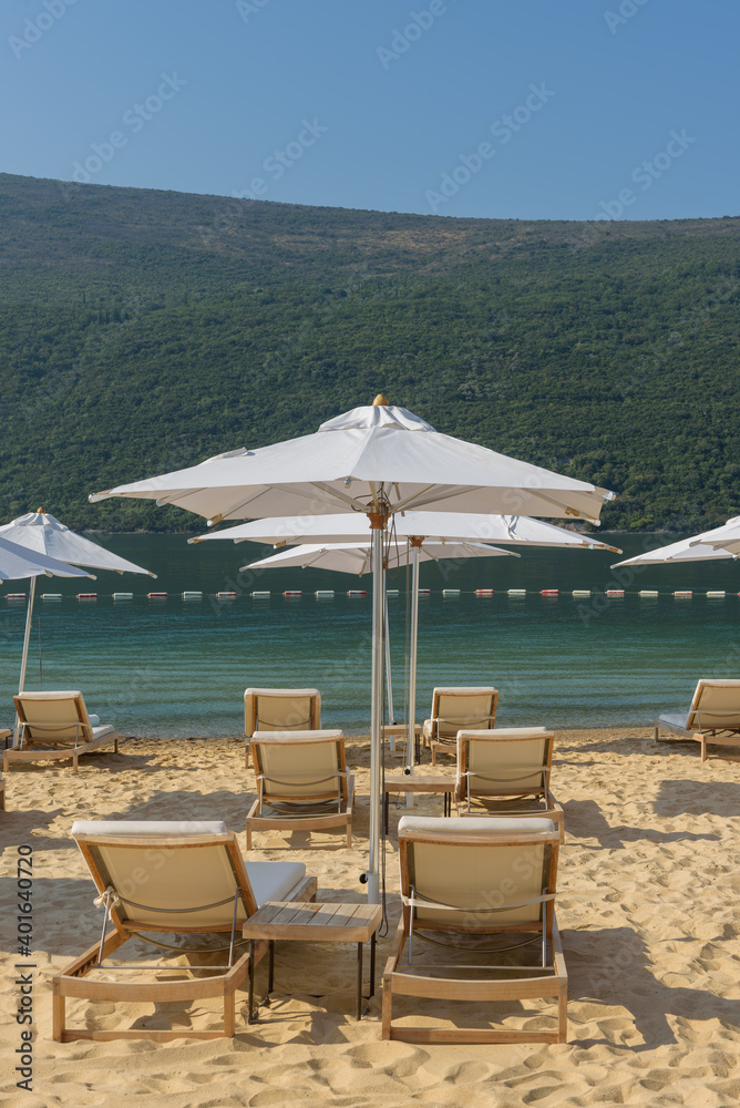 Umbrellas and beach loungers on golden beach