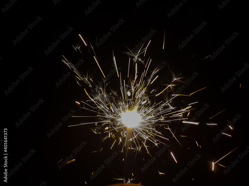 Burning sparkler producing spark around, celebration with fireworks and crackers during X mas and new year Burning sparkler producing spark around, celebration with fireworks and crackers during X mas and new year
