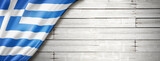 Greek flag on old white wall banner