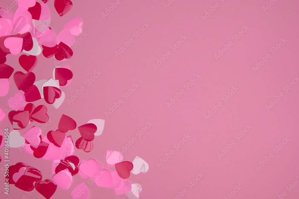 Valentine day composition with copy space. Frame made of confetti hearts red and pink on pastel background. Close up, top view, copy space