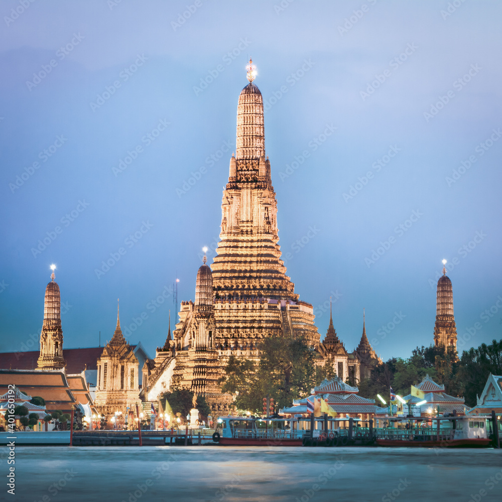 Wat Arun, The Temple of Dawn, at twilight, view across Chao Phraya river. Bangkok, Thailand.