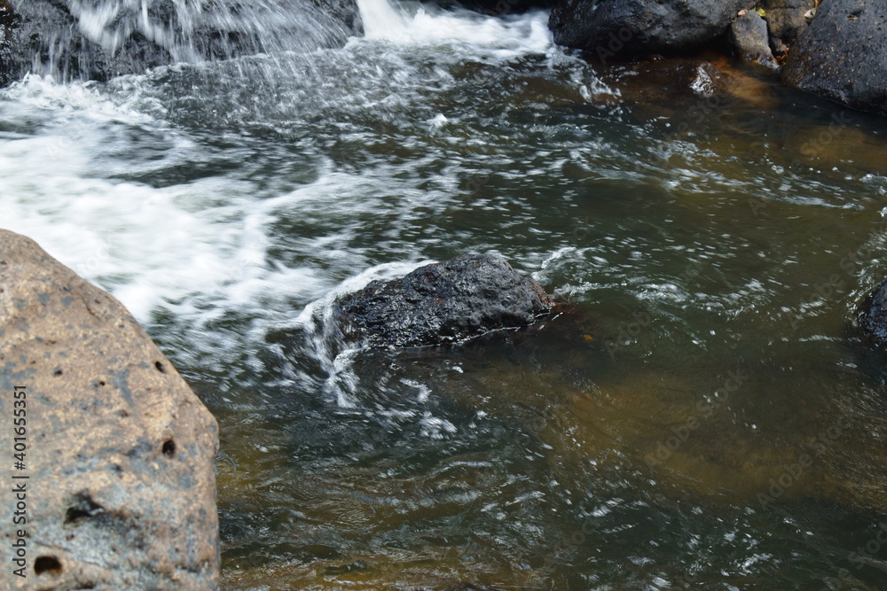 water falling on river pass rock and stone at Nang Rong waterfall ...