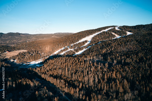 Drone photo shot from the sky. Countryside just outside of Oslo, Norway. Fields and wood mixed together. 