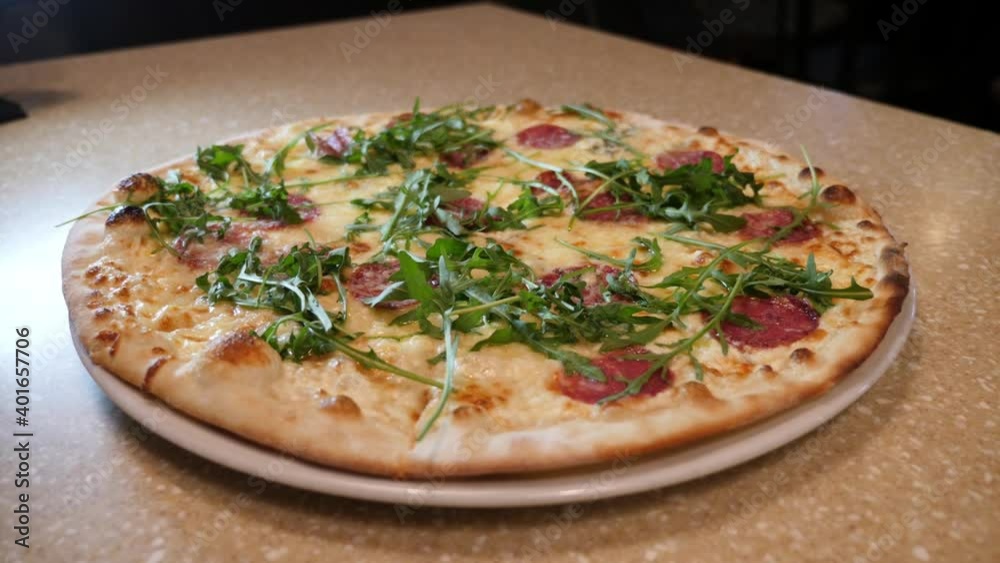 Serving the finished pizza to the table. Ready pizza dish Serving the finished pizza to the table. Ready pizza dish
