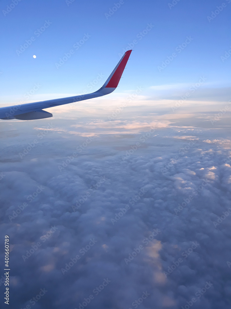 Airplane wing through the clouds in the sky. Airplane wing through the clouds in the sky.