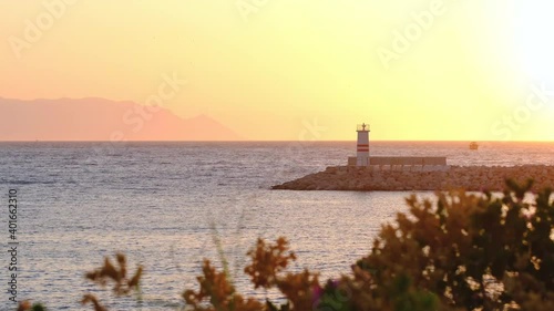 Lighthouse on sunset in Kusadasi Town, Aydin, Turkey. Dramatical and romantic moment. Kusadasi Town is very famous and popular touristic place in Turkey.