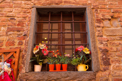 Potted plants grow in terracotta containers outside in the town of Certaldo  in the heart of Tuscany  Italy.