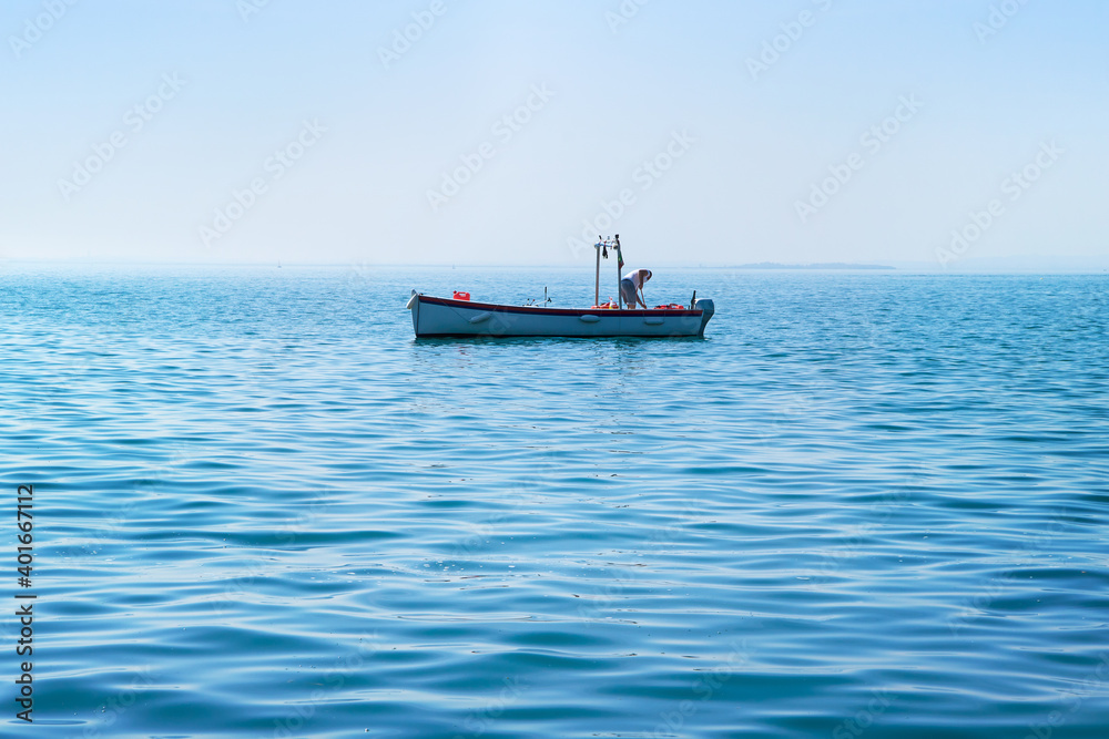 boat maintenance work, man who works to keep the ship clean in the water (copy space available at the bottom of the photo)