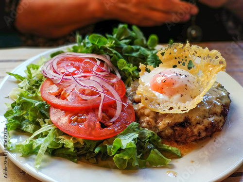 Hamburger steak with cheese, fried egg and salad