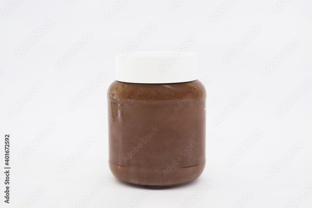 Glass jar with tasty chocolate cream isolated on white Glass jar with tasty chocolate cream isolated on white