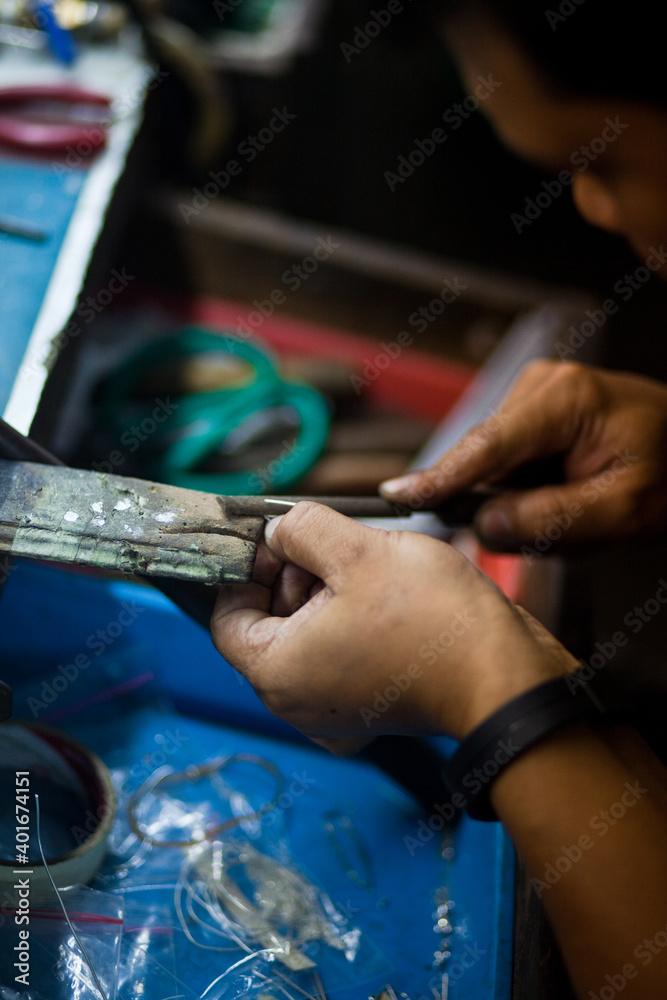Fototapeta premium Working desk for craft jewelery making with professional tools. Silver production. Master's hands