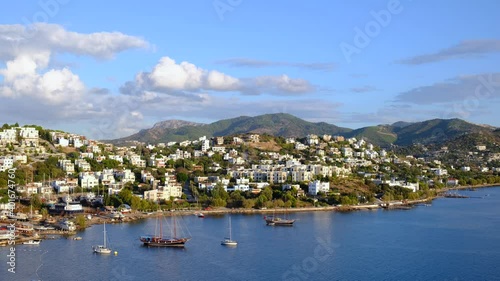 White Aegean houses of Yalikavak next to sea and yachts at sunset in Bodrum, Turkey. Bodrum is most popular summer vacation area for tourist in Turkey. 