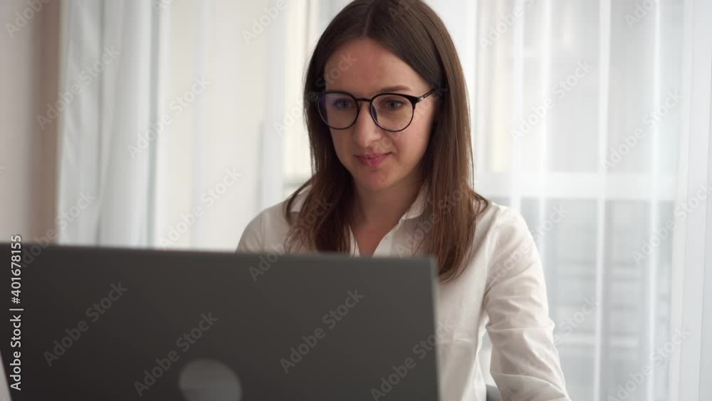 Young business woman talks to web camera making distance online video conference call. Female internet teacher doing distant chat working from home. Telework concept.