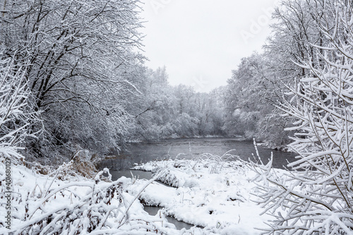 Winter scenery at the river Liela Jugla with tree branches full of snow in December in Latvia photo