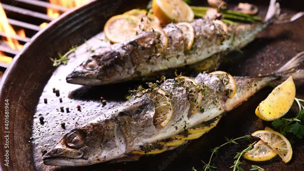 Grilled fish and various vegetables in iron plate Grilled fish and various vegetables in iron plate