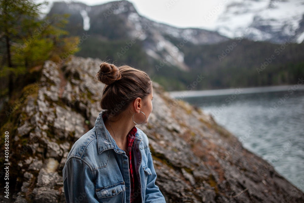 young woman in alps mountains and alpine lake on background. Travel Italy, Europe. young woman in alps mountains and alpine lake on background. Travel Italy, Europe.
