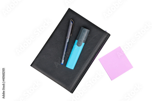 Black leather notebook with a pen and marker, isolated on white background
