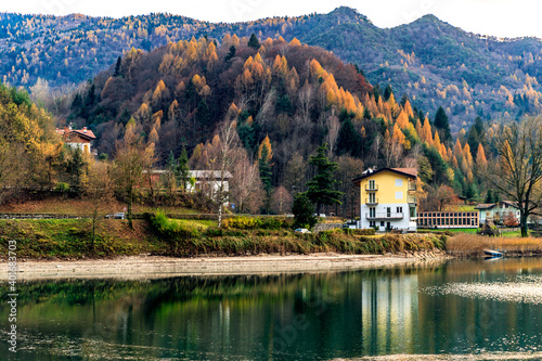 lake with a house and mountain background